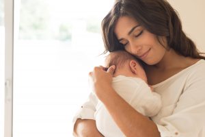 Woman holding a newborn baby in her arms