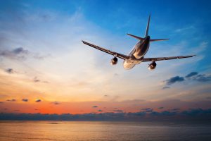 Airplane flying at sunset